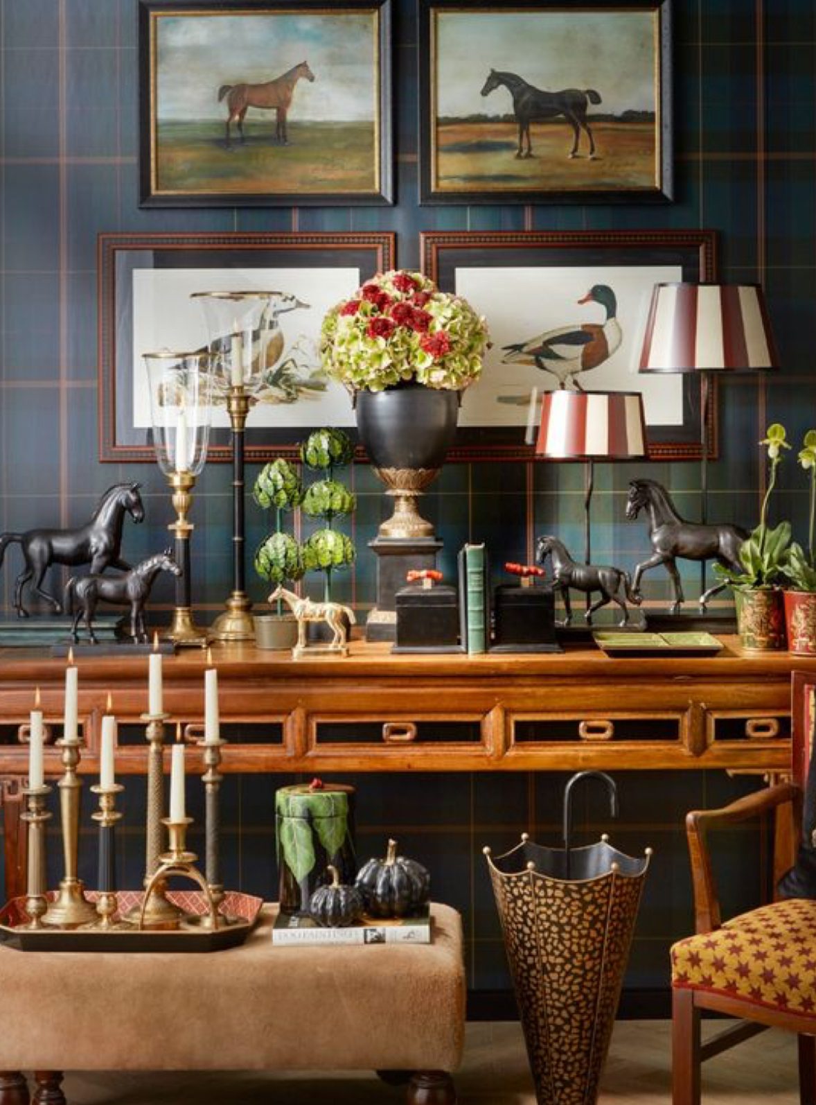 Elegant vintage wooden console table with decorative items and floral centerpiece.