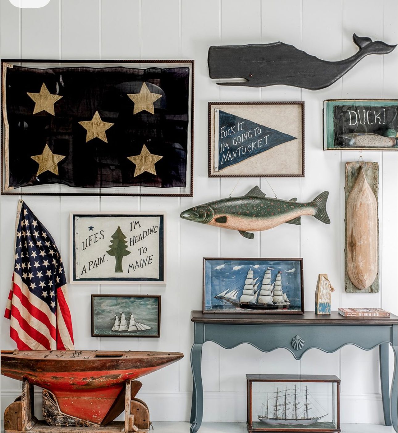A nautical-themed wall display with various maritime decorations and flags.