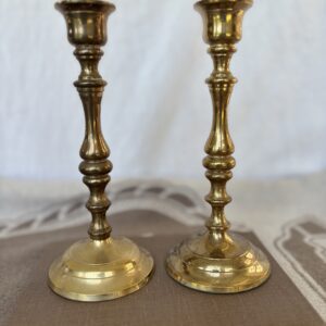 A pair of vintage brass candlesticks with intricate detailing.