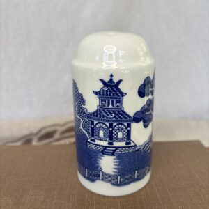 Blue and white ceramic jar with pagoda design.