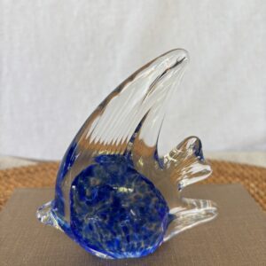 A glass fish sculpture with blue accents inside.