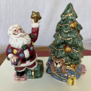 Festive Santa and Christmas tree figurines with gifts and an owl.