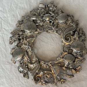 Decorative silver wreath adorned with various sea creatures and shells.