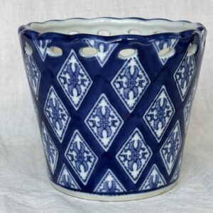 Blue and white ceramic pot with diamond patterns.