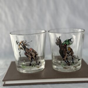 Two clear glasses with painted cowboy and horse designs.